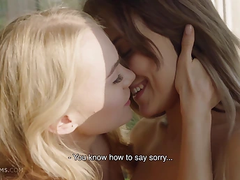 Two naked women making out passionately on the bed